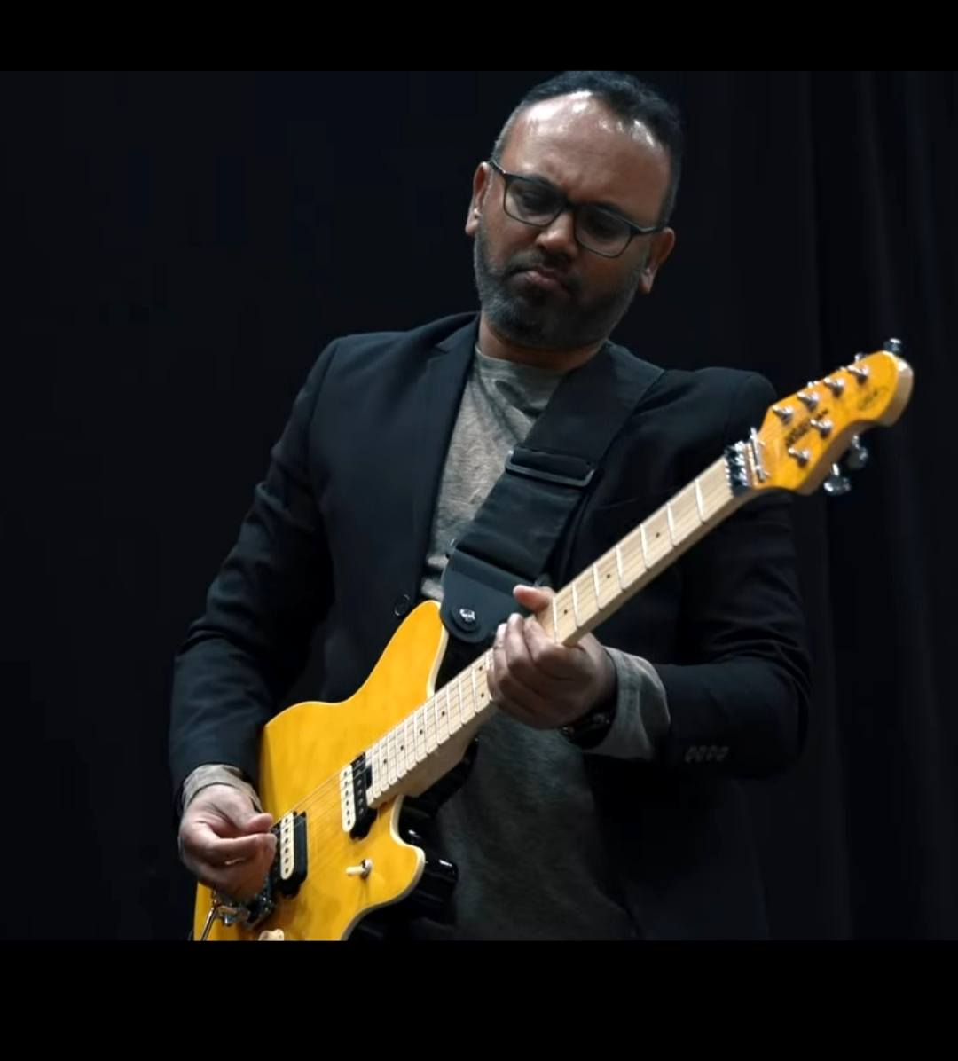 Moncy Abraham performing onstage in 2025